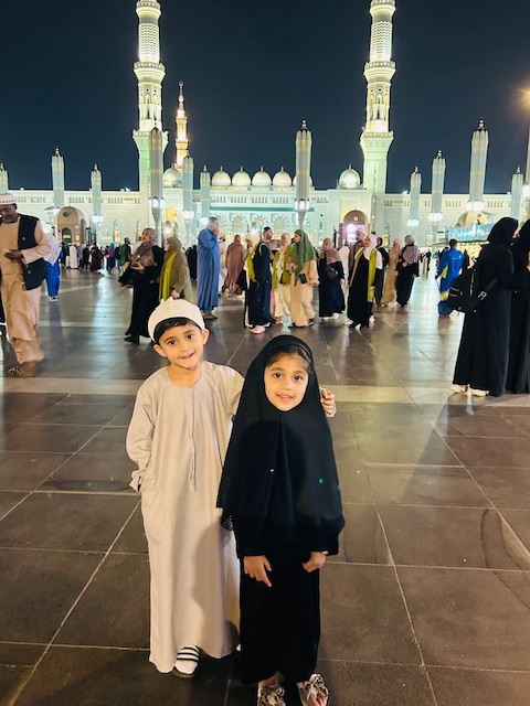 Young pilgrims outside Masjid an-Nabawi, Madinah, at night